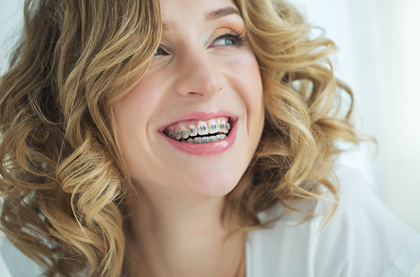 a patient with braces smiling