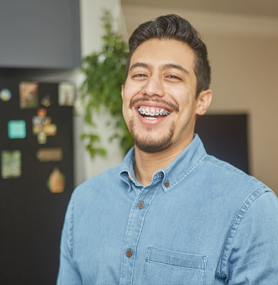 Smiling adult man with braces