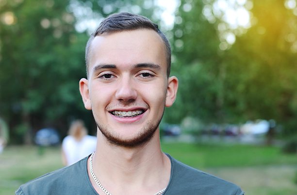 a man with clear braces smiling