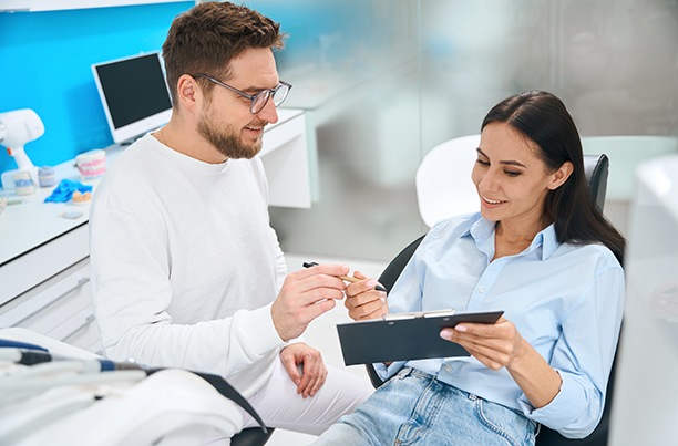 a woman reviewing a dental form
