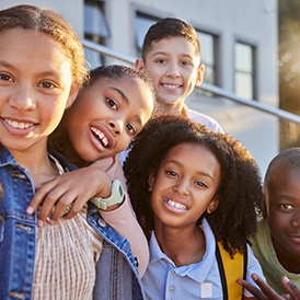 a group of children smiling happily