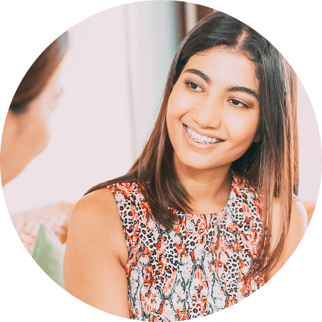 Smiling patient talking to orthodontist about financing