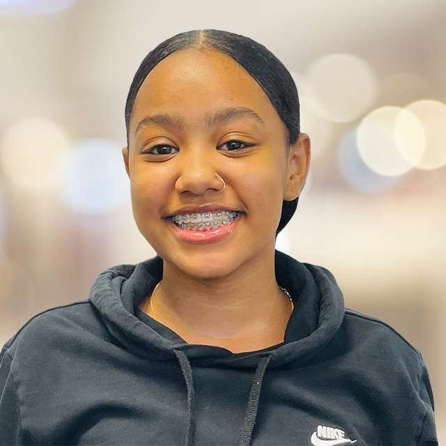 Teen girl with traditional braces smiling