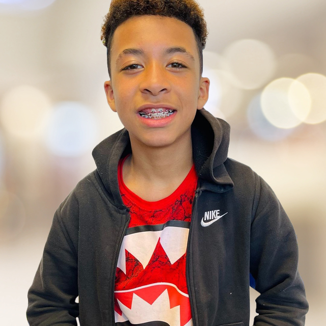 Teen boy with braces smiling