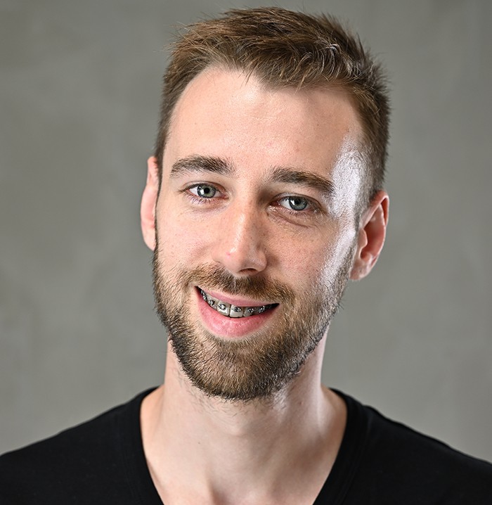 Smiling man with braces