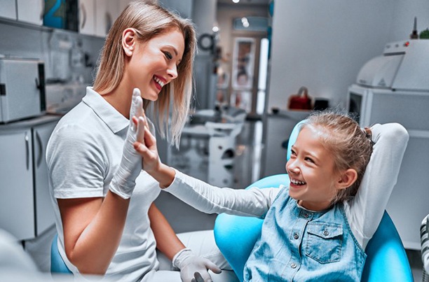 Little girl giving dentist a high-five