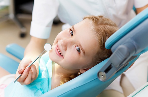 Little girl smiling in the treatment chair