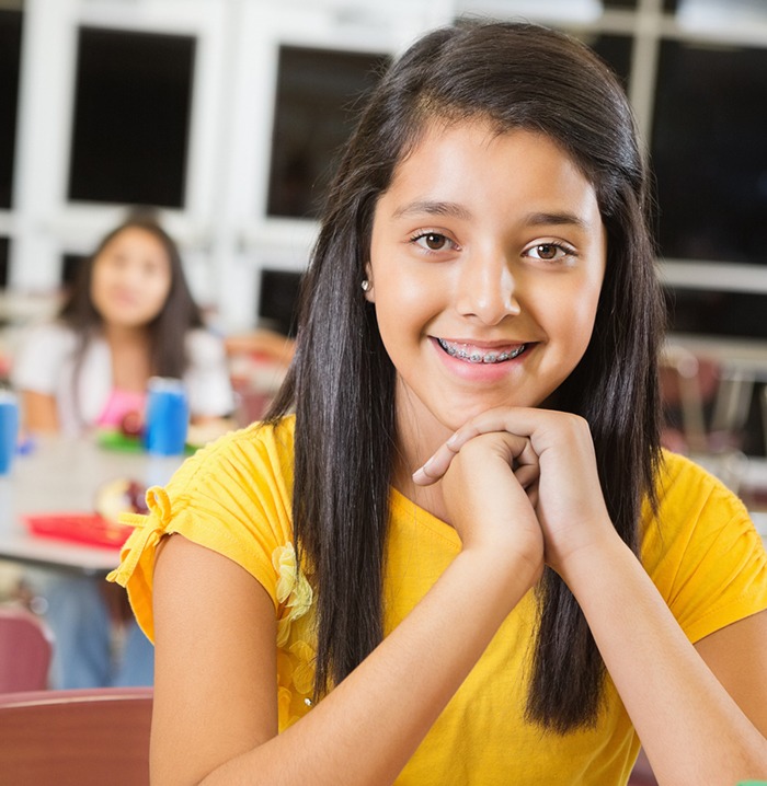 Young girl with pediatric orthodontics smiling