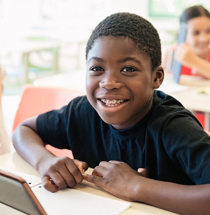 Preteen boy smiling during orthodontic services