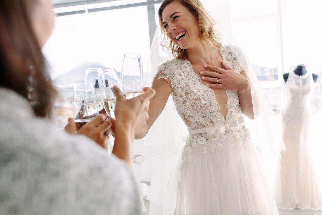 Bride with beautiful smile with friends on wedding day