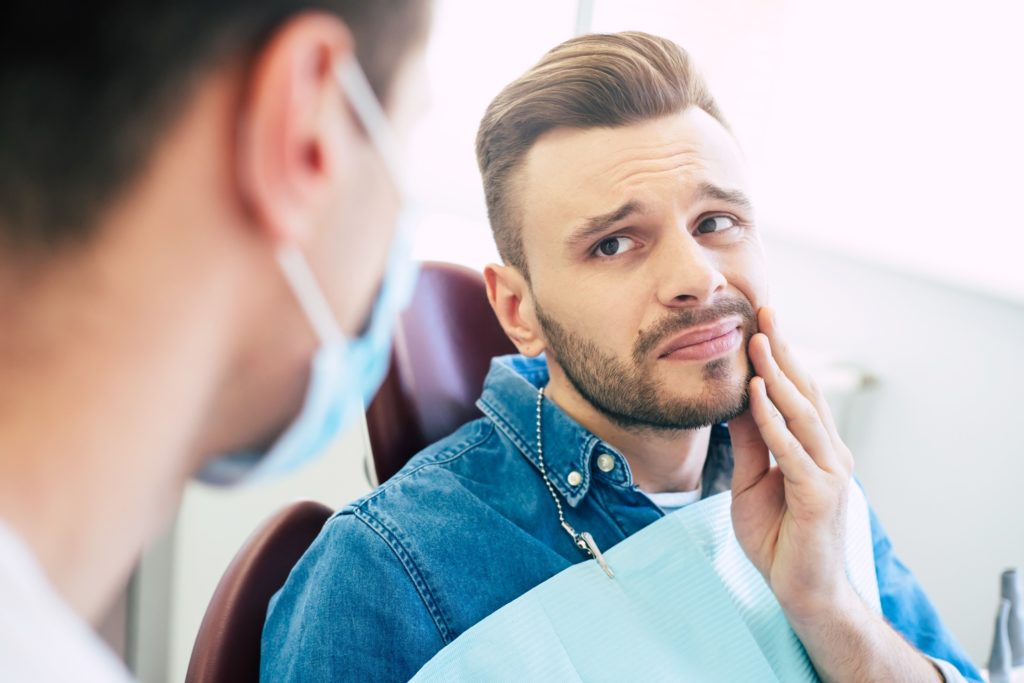 Closeup of man experiencing jaw pain