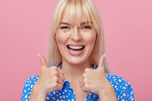 a patient with clear braces smiling