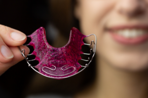 a patient holding their retainer